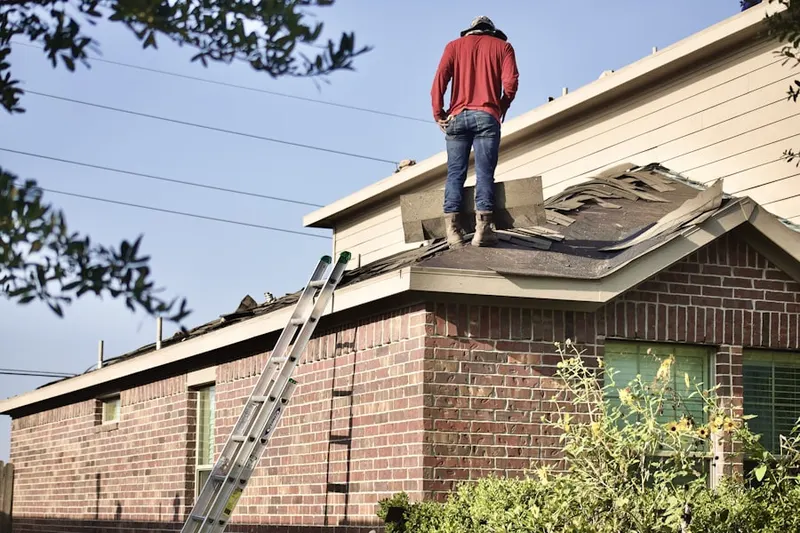 Professional roofer working on a residential roof in Carolina Forest